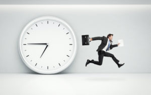 Busy Businessman running from oversized clock