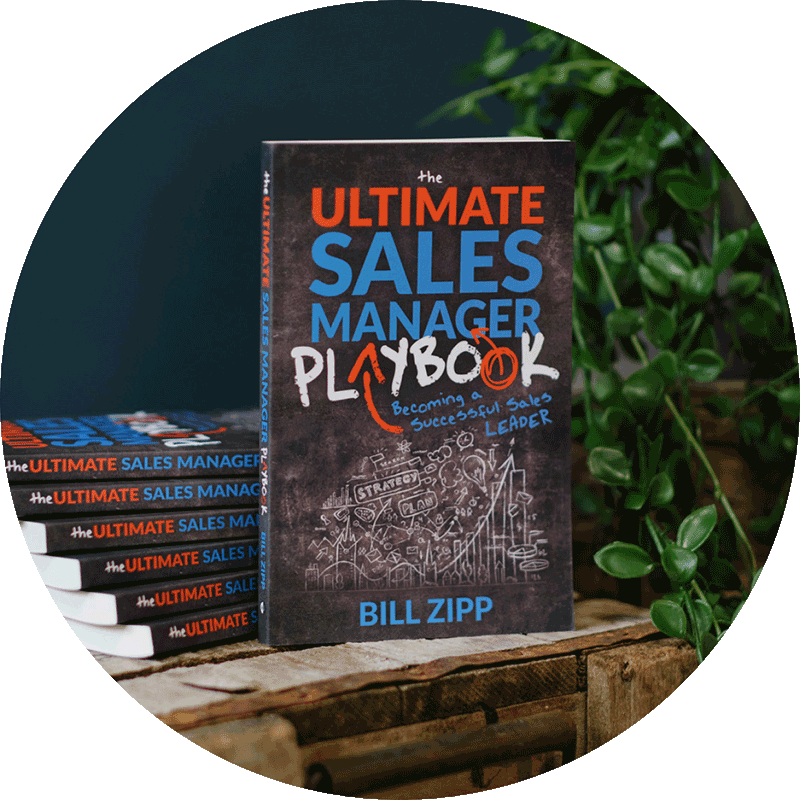 Stacks of Ultimate Sales Manager Playbook on Table