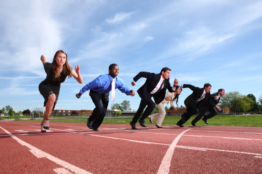 Businesspeople on a running track to represent quarterly sprints