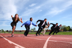 Businesspeople on a running track to represent quarterly sprints